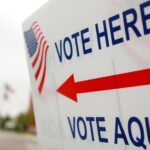 "Vote here, vote aqui" by whiteafrican is licensed under CC BY 2.0.