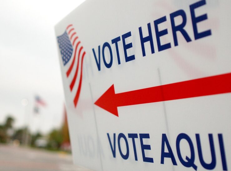 "Vote here, vote aqui" by whiteafrican is licensed under CC BY 2.0.